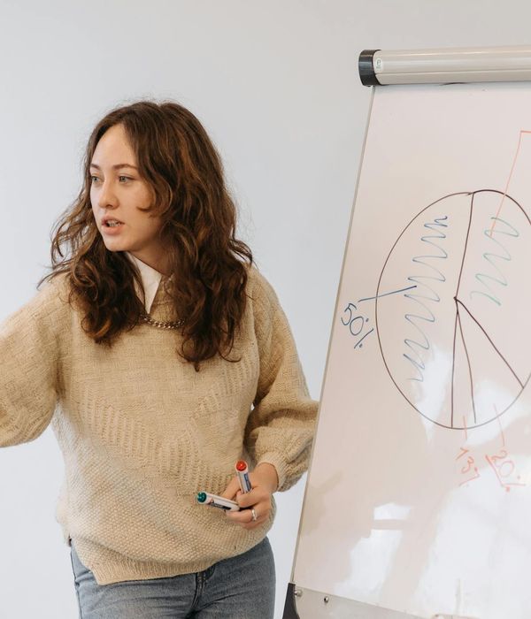 Woman professional presenting strategic business analysis at corporate meeting